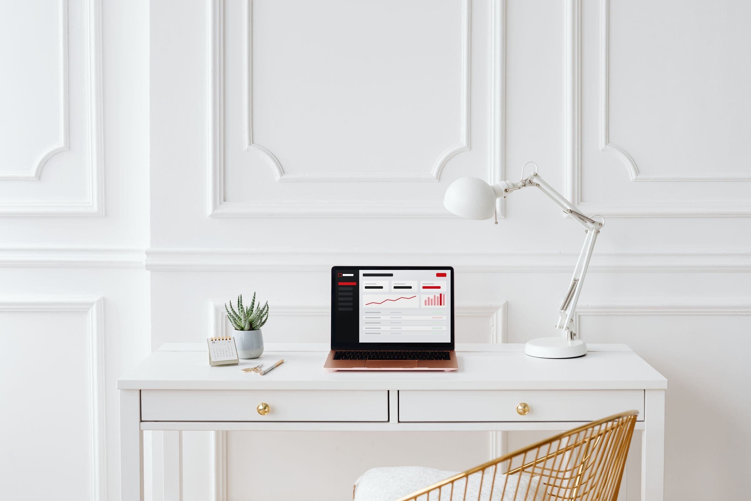 Laptop on a white desk showing an account dashboard